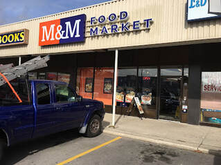 Exterior of a meat shop with a large blue truck parked outside in Waverley, Guelph, Ontario