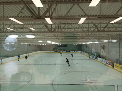 Indoor skating rink with people playing hockey in Exhibition Park,  Guelph, Ontario