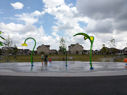 Splash pad with arched slender tall green spouts in Brant,  Guelph, Ontario