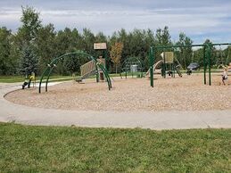 Exterior of a sand ground playground struture in a park in Grange Hill East, Guelph, Ontario