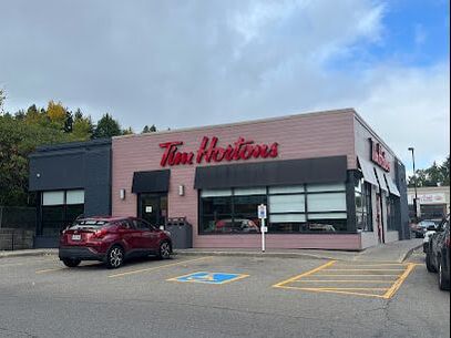 Exterior of a Tim Hortons restaurant and parking lot in Parkwood Gardens, Guelph, Ontario
