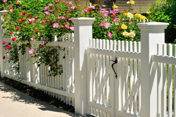 Four feet high white vinyl fence in a yard in Grange Hill East, Guelph, Ontario